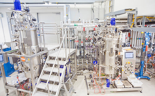 Large industrial fermentation plant made of stainless steel with multiple reactors