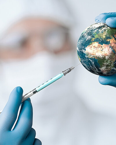 Pandemic concept, close up of scientist injecitng vaccine into the earth