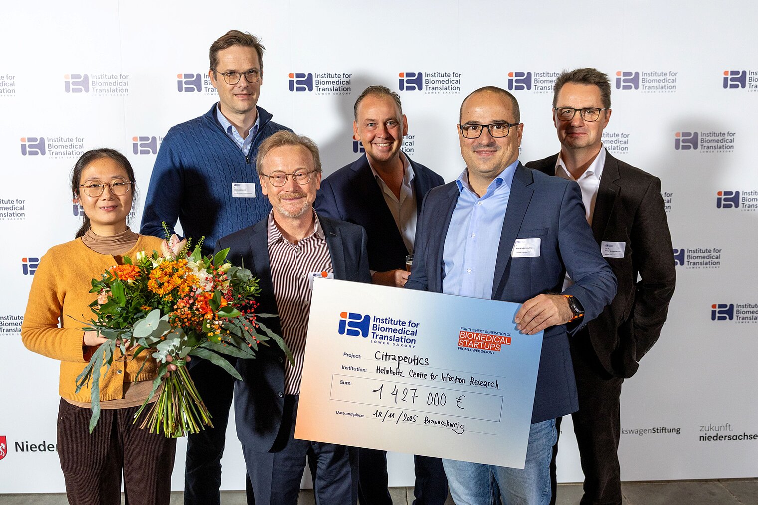Group picture of 6 people with an oversized cheque