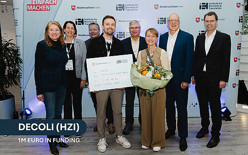 group photo of 8 persons with funding check