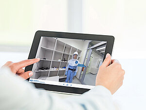 A person holding a tablet with a preview of a virtual tour of the HZI
