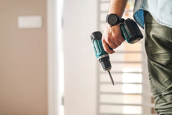 Person with cordless screwdriver