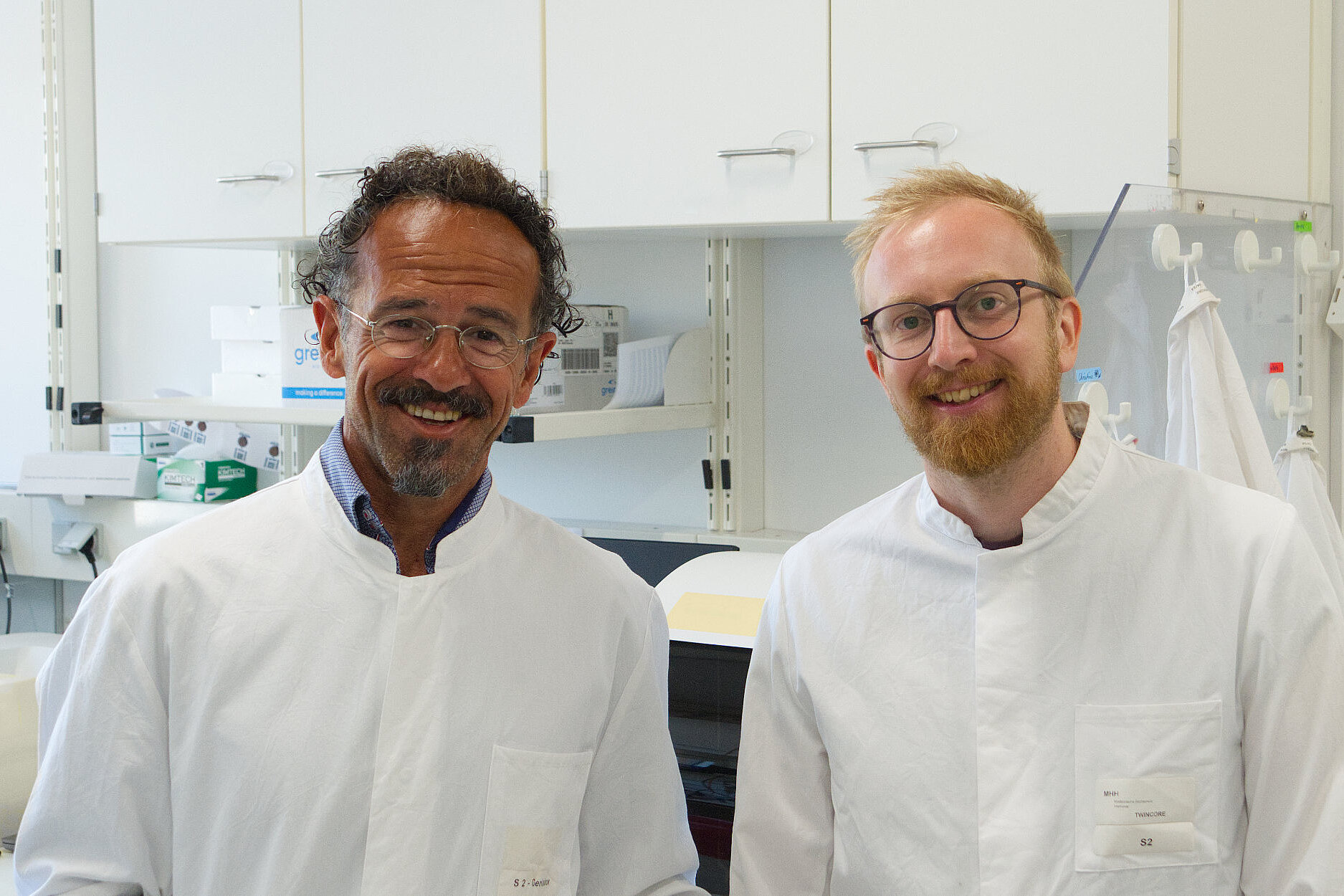 Two people in the lab, smiling at the camera