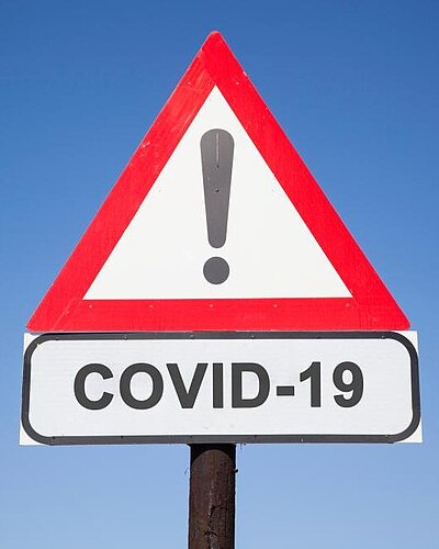 Street sign "Attention COVID-19"