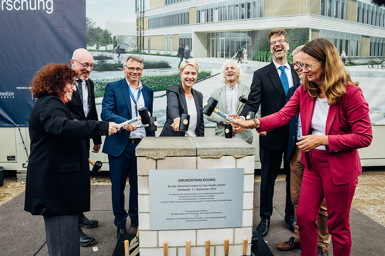 With great enthusiasm, the time capsule is being sealed.