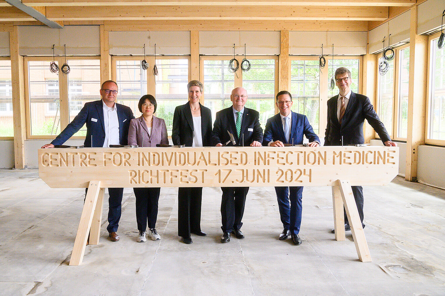 Group photo from topping out ceremony: (left to right) Cornberg, Li, Debarry, Manns, Mohrs, Scherf