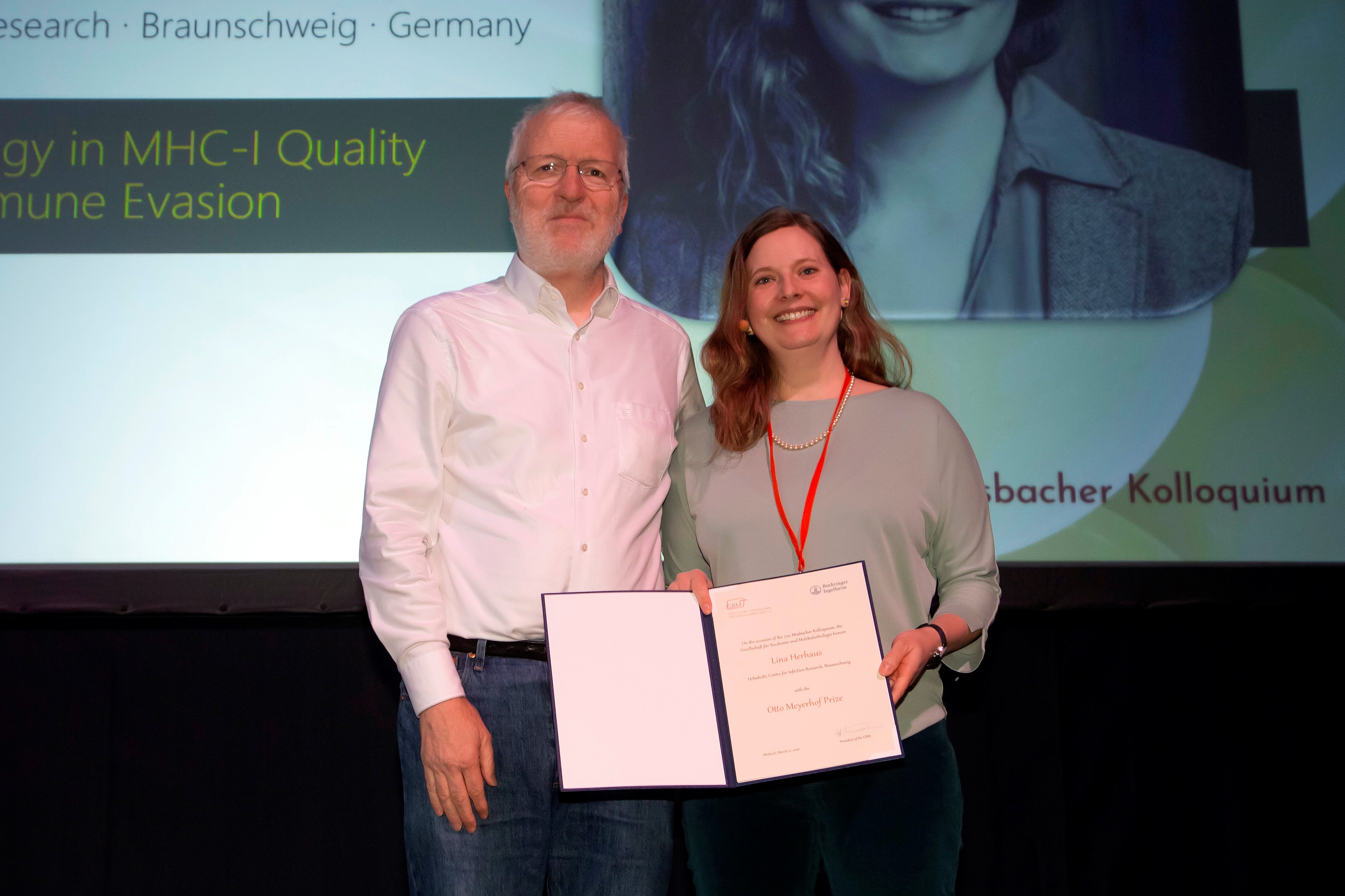 A man and a woman, who holds a certificate